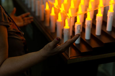 People pray in front of candles inside the campo santo church on the day of the dead holiday 