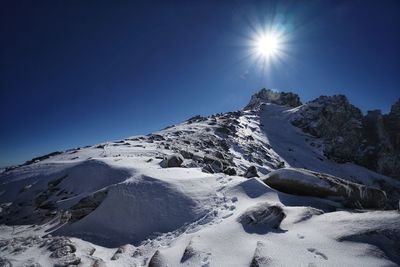 Scenic view of snowcapped mountains against clear blue sky