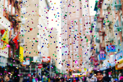 Close-up of multi colored confetti in city