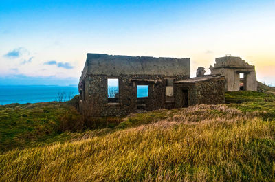 Old building on field against sky