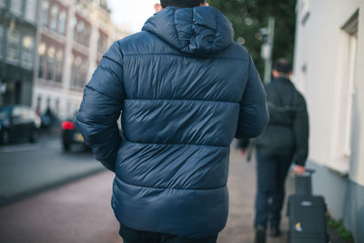 Rear view of woman standing in city