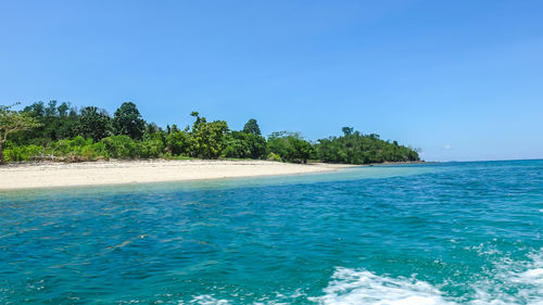 Scenic view of sea against clear blue sky