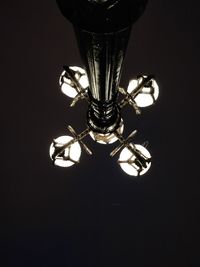 Close-up of illuminated lamp against black background