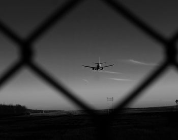 Low angle view of airplane flying against clear sky