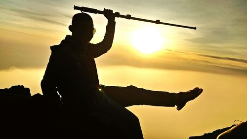 Low angle view of silhouette statue against sky during sunset