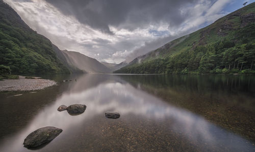 Scenic view of lake and mountains against sky