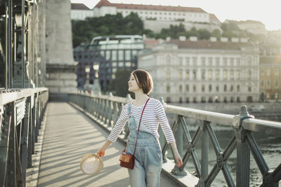 Man standing on bridge