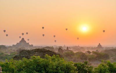 Hot air balloons against sky during sunset