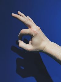 Cropped image of hand gesturing okay sign