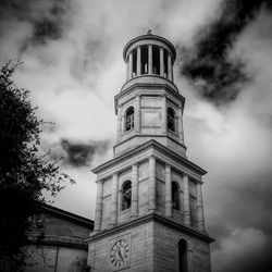 Low angle view of building against cloudy sky