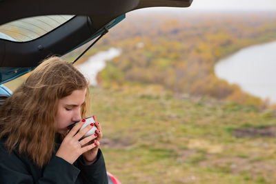 Portrait of young woman in car