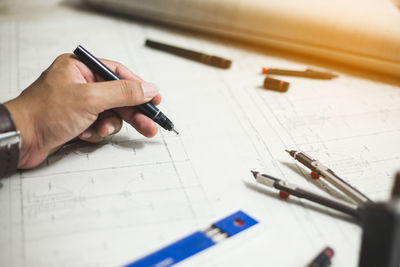 High angle view of man working on paper