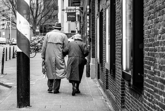 building exterior, architecture, built structure, rear view, full length, men, walking, city, lifestyles, city life, person, street, casual clothing, building, sidewalk, the way forward, day