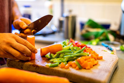 Midsection of man preparing food on cutting board