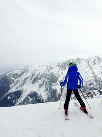 Rear view of person skiing on snow landscape