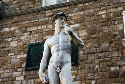 Low angle view of statue against wall