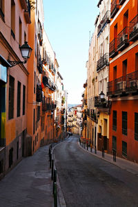 Street amidst buildings in city against sky