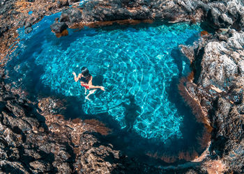 High angle view of man swimming in sea