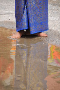 Low section of woman standing on wet floor