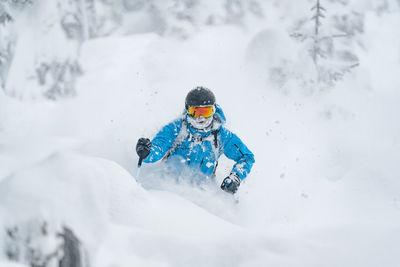 Adult man skiing in deep powder snow in the backcountry, werfenweng, austria.