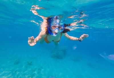 Portrait of woman snorkeling in sea