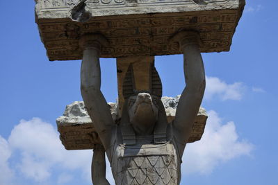 Low angle view of statue against sky