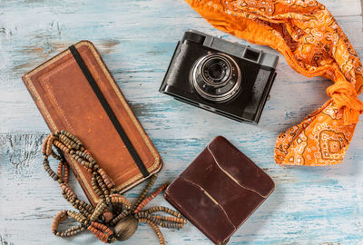 Close-up high angle view of wallets and camera