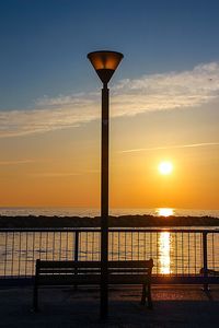 Pier on sea at sunset