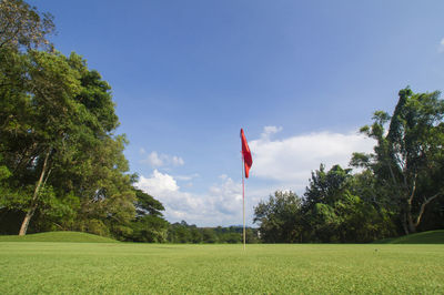 Scenic view of golf course against sky