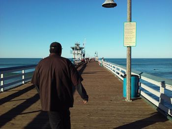 Rear view of man standing on beach