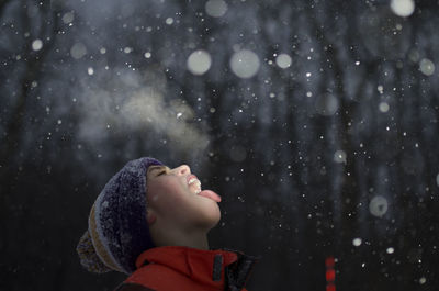 Boy with mouth open during snowing