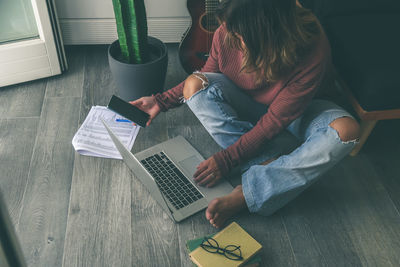 Young woman working on laptop at home. female hands typing on pc keyboard.  girl studying online.