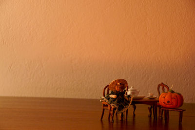 Stuffed toy on table against wall
