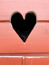 Close-up of heart shape on brick wall