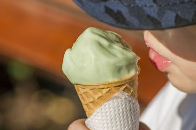A boy holding a cone of ice cream