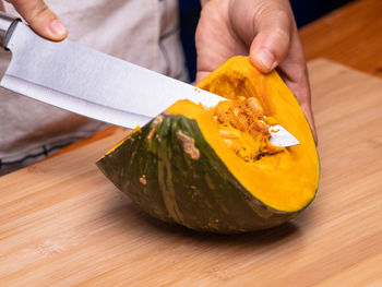 Close-up of person preparing food on cutting board