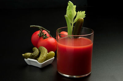 Close-up of red bell peppers on table against black background