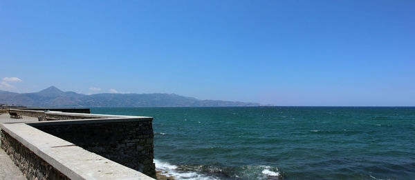 Scenic view of sea against clear blue sky