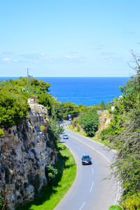 High angle view of road by sea against sky