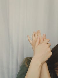 Midsection of woman against wall at home