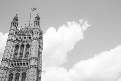 Low angle view of building against cloudy sky