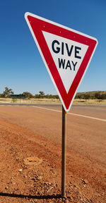 Road sign against clear sky