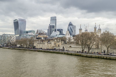 River by buildings against sky in city