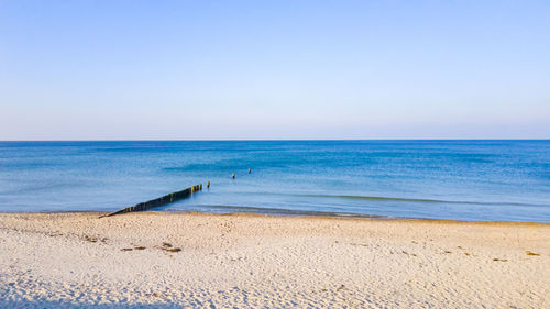 Scenic view of sea against clear blue sky