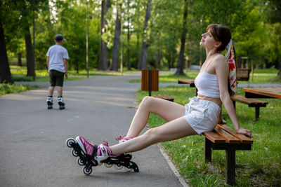 Side view of young woman exercising in park