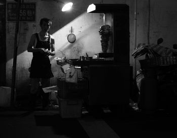 Woman standing in illuminated room