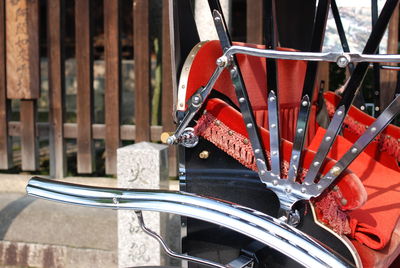 Bicycle parked by metal chair