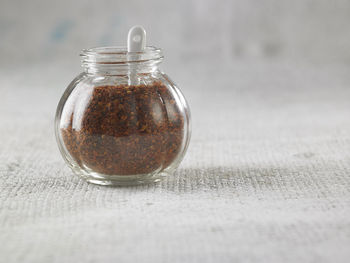 Close-up of spice in jar on table