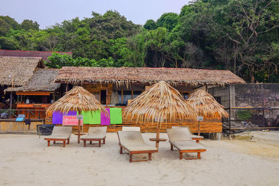 Lounge chairs on beach against building