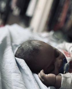 Close-up of baby sleeping on bed